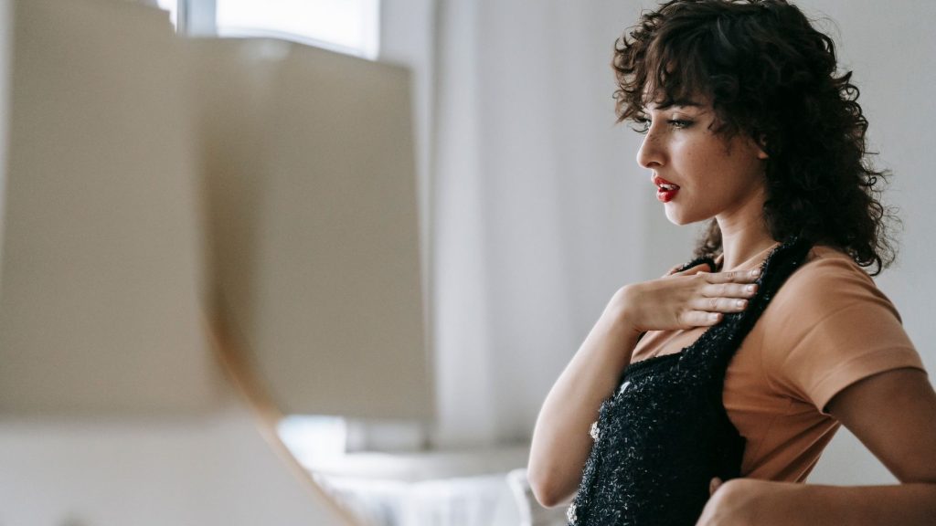 Femme près d’une fenêtre avec une tasse, ambiance calme